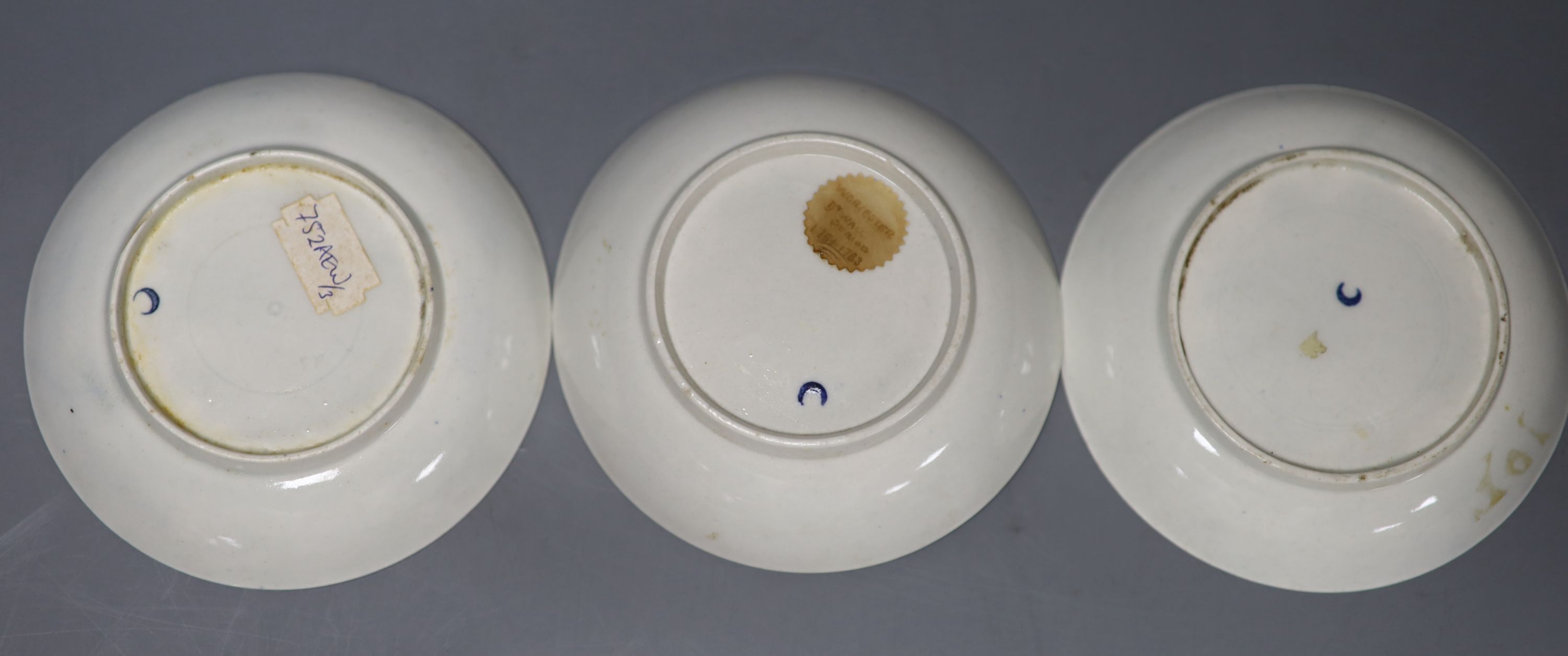 Three 18th century Worcester tea bowls and saucers, two printed with Three Flowers and one printed with the Fence pattern most with cre